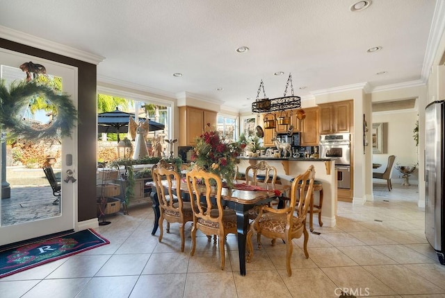 tiled dining area featuring ornamental molding