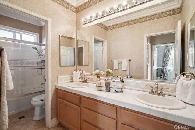 full bathroom with toilet, vanity, tile patterned flooring, tiled shower / bath combo, and ornamental molding