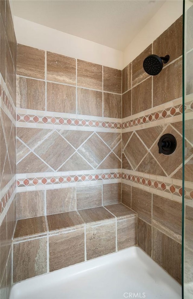 bathroom with tiled shower