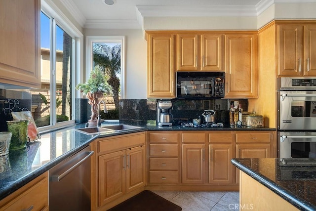 kitchen featuring black appliances, light tile patterned floors, sink, and dark stone countertops