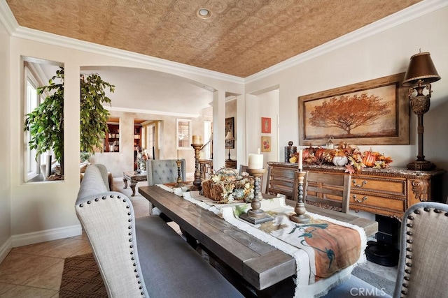 dining area with crown molding and light tile patterned flooring