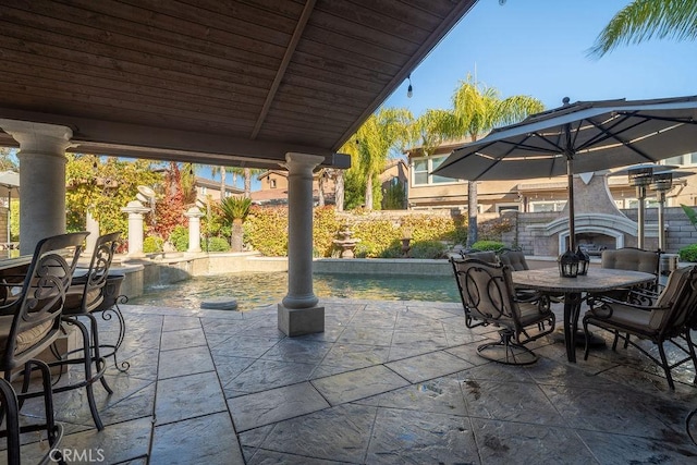 view of patio featuring an outdoor fireplace