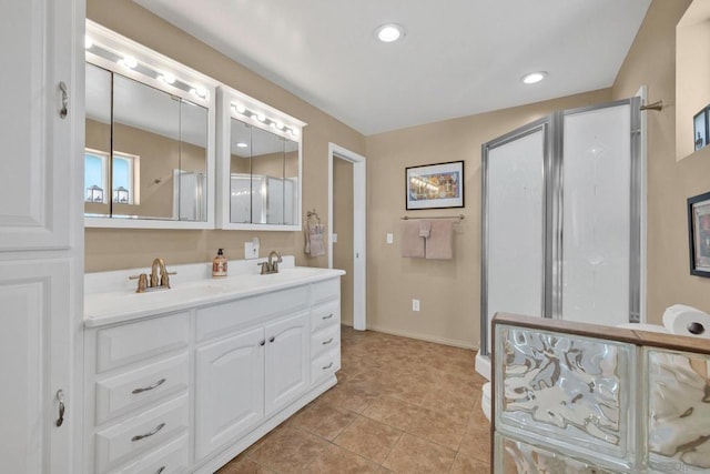 bathroom with tile patterned flooring, a shower with shower door, and vanity