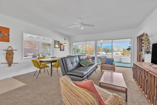 living room with ceiling fan and carpet