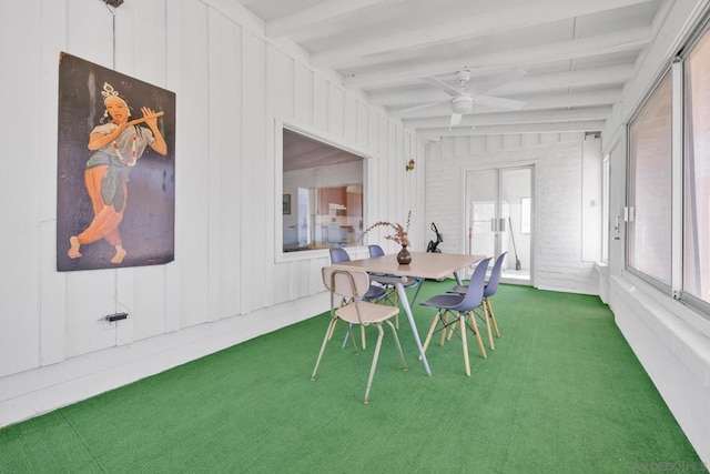 sunroom featuring ceiling fan and beam ceiling