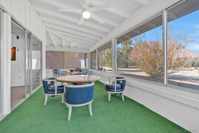 sunroom with ceiling fan and lofted ceiling