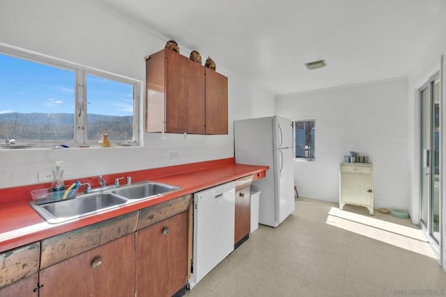 kitchen featuring a mountain view, sink, and white appliances