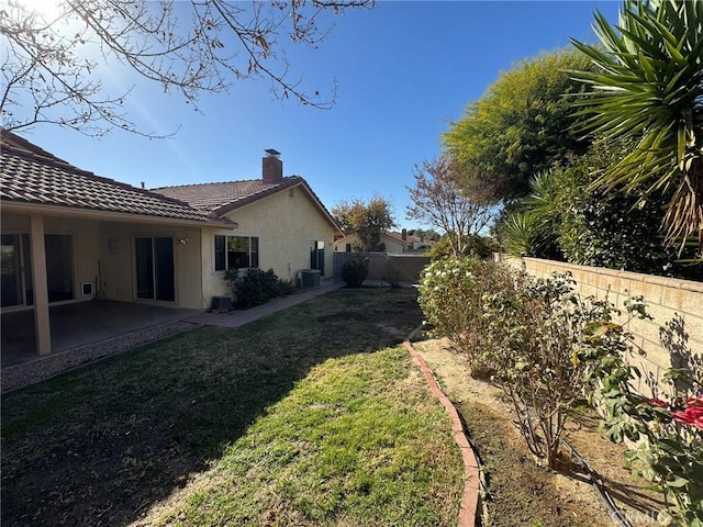 view of yard featuring cooling unit and a patio