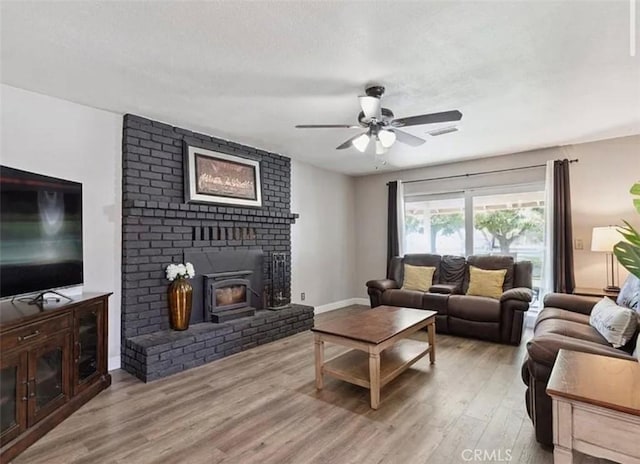 living room with ceiling fan and light wood-type flooring