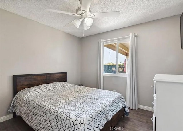 bedroom featuring ceiling fan, dark wood-type flooring, and a textured ceiling