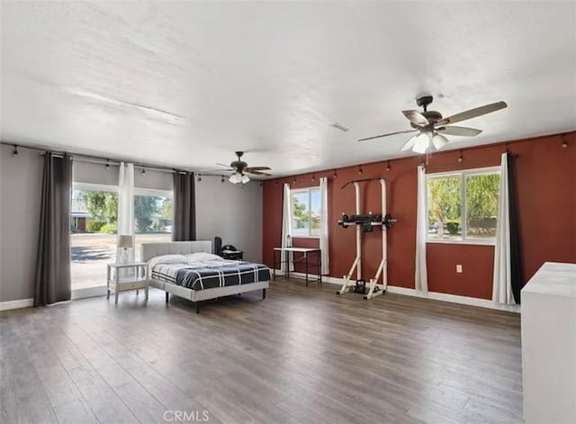 bedroom with ceiling fan and dark hardwood / wood-style floors