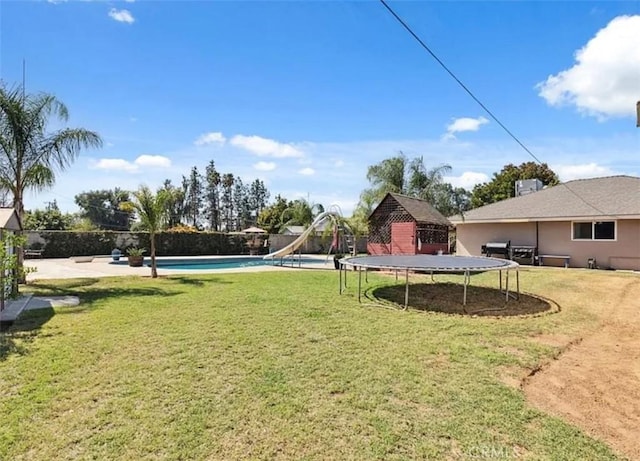 view of yard with a gazebo, a fenced in pool, and a trampoline