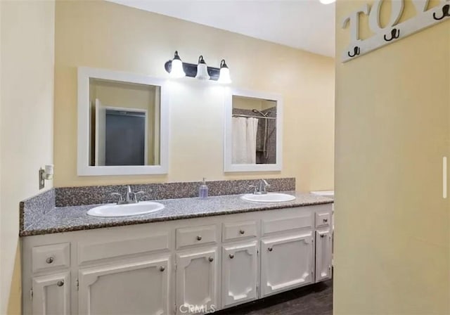 bathroom with a shower with curtain and vanity