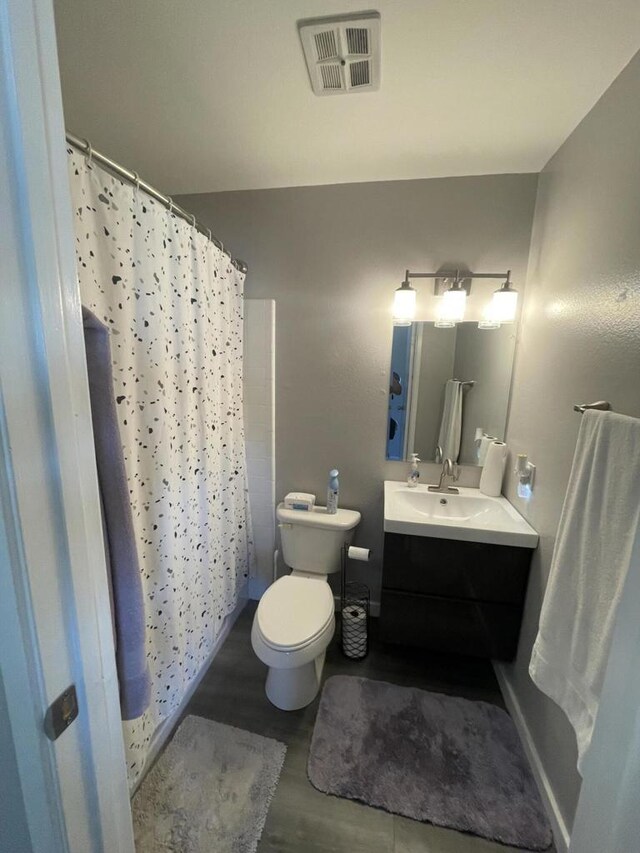 bathroom featuring toilet and vanity