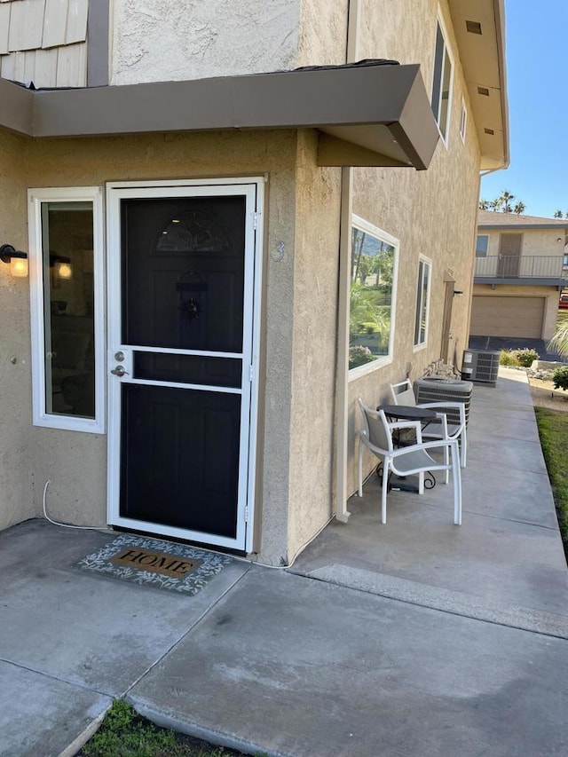 doorway to property with a patio area