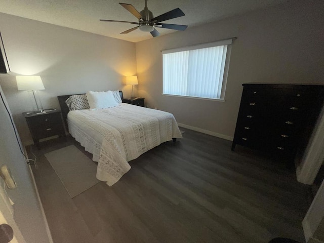 bedroom featuring ceiling fan and dark hardwood / wood-style floors