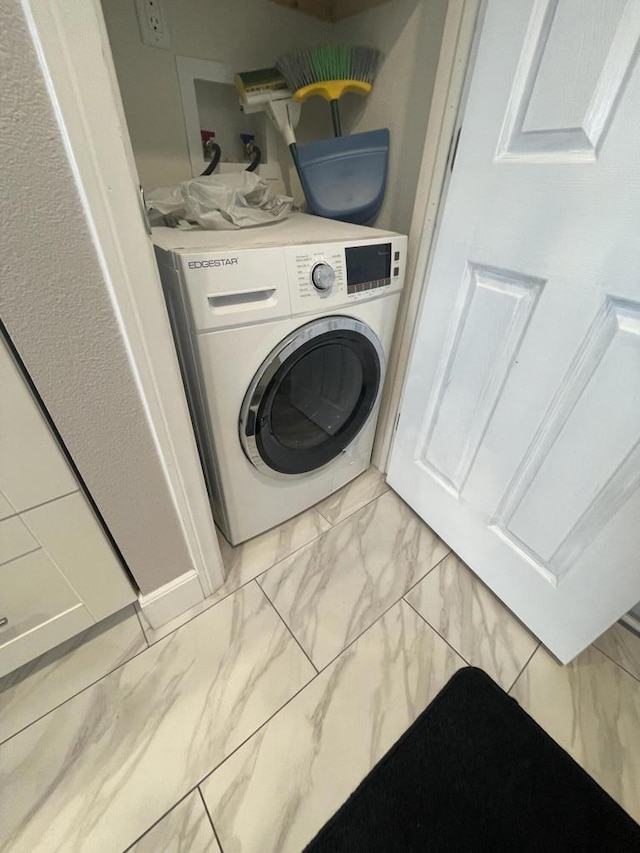 clothes washing area featuring washer / dryer