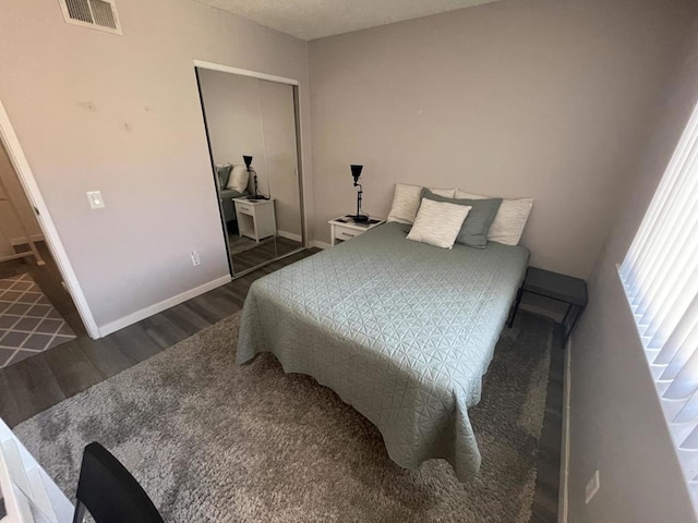 bedroom with dark wood-type flooring