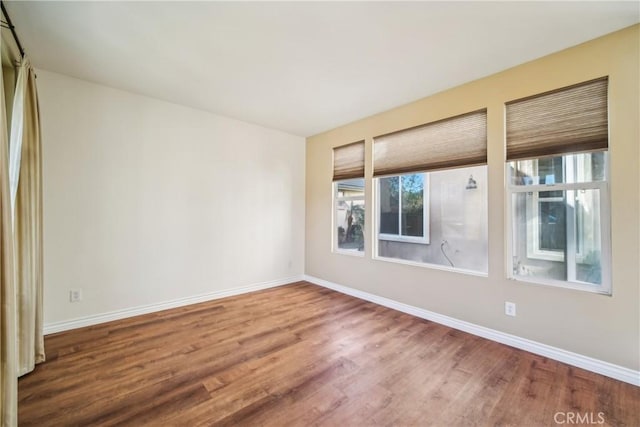 spare room with hardwood / wood-style floors