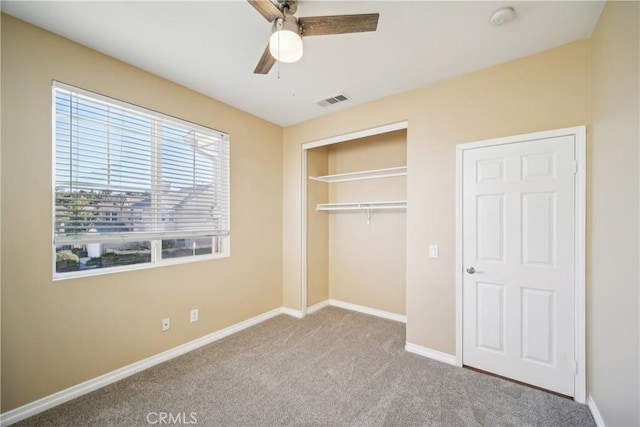 unfurnished bedroom with light carpet, a closet, and ceiling fan