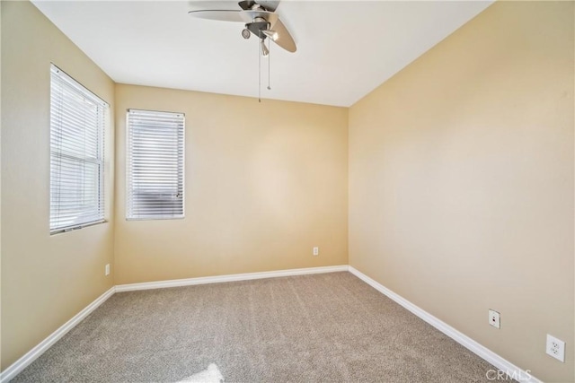 carpeted empty room featuring ceiling fan