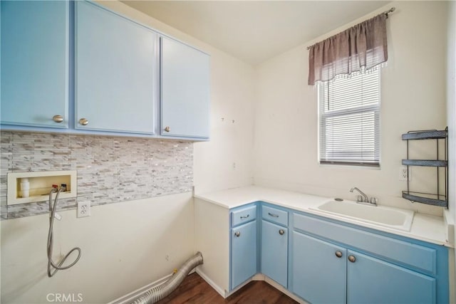 laundry area featuring washer hookup, dark hardwood / wood-style floors, cabinets, and sink