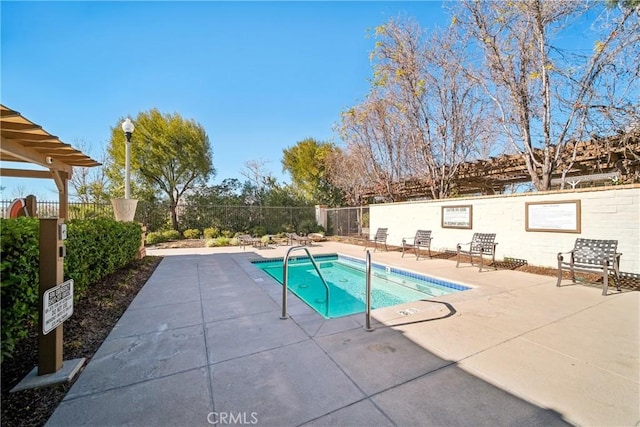 view of swimming pool featuring a patio and a hot tub