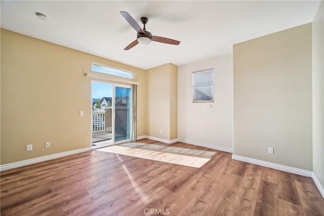 spare room with hardwood / wood-style flooring and ceiling fan