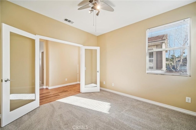 unfurnished bedroom with carpet flooring, french doors, and ceiling fan