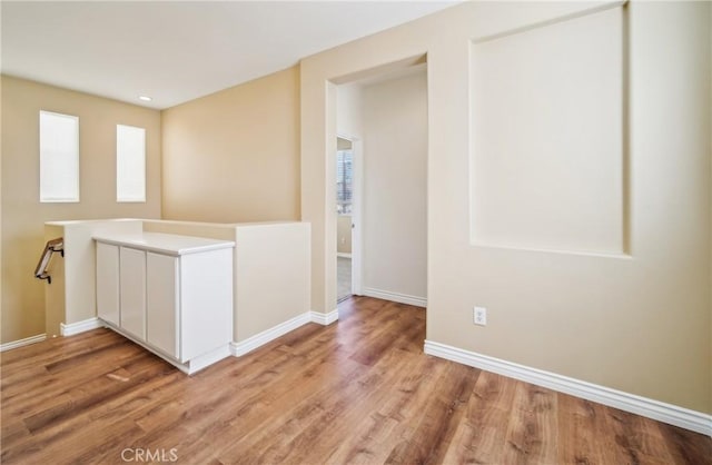 interior space featuring white cabinets and light hardwood / wood-style flooring