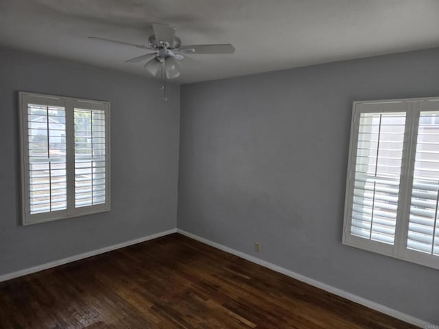 spare room featuring ceiling fan and dark hardwood / wood-style flooring