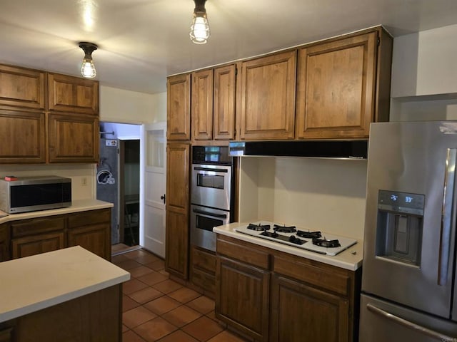 kitchen featuring tile patterned floors and stainless steel appliances