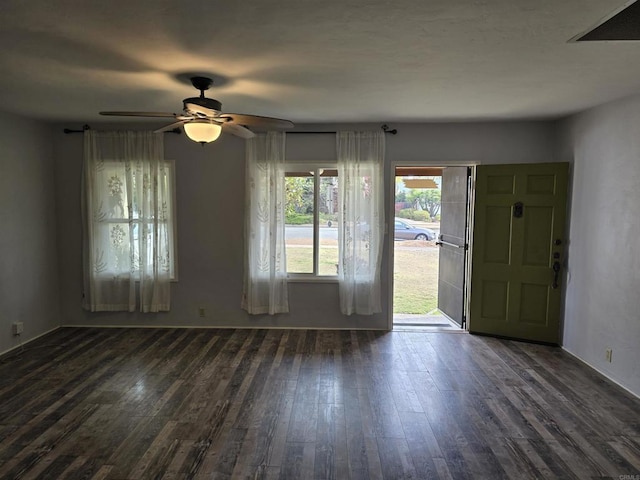 interior space with ceiling fan and dark hardwood / wood-style floors