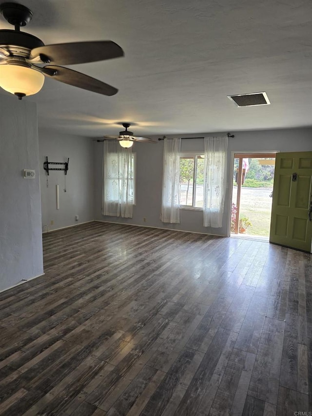 unfurnished living room with ceiling fan and dark hardwood / wood-style flooring