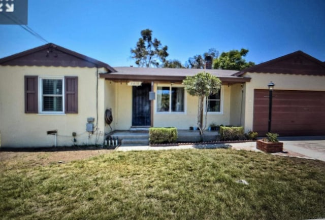 single story home with a front lawn and a garage