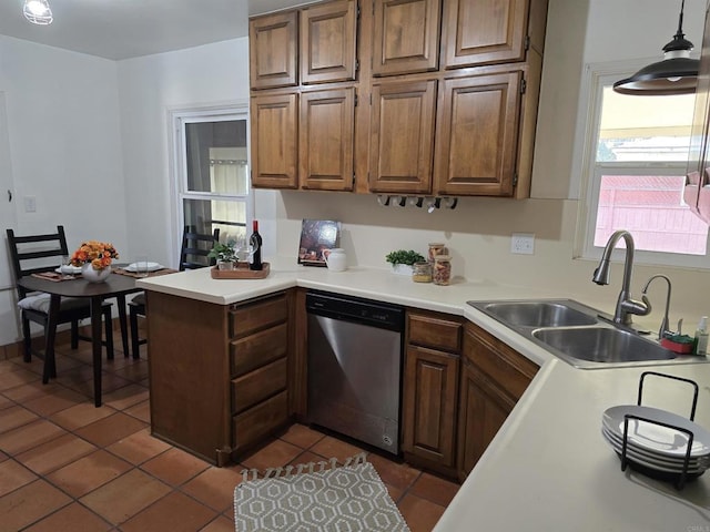 2416 J Ave, National City, CA 91950 - kitchen featuring stainless steel dishwasher, a sink, dark tile patterned flooring, a peninsula, and light countertops