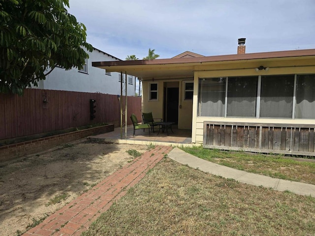 2416 J Ave, National City, CA 91950 - back of property featuring a patio area, fence, and a chimney