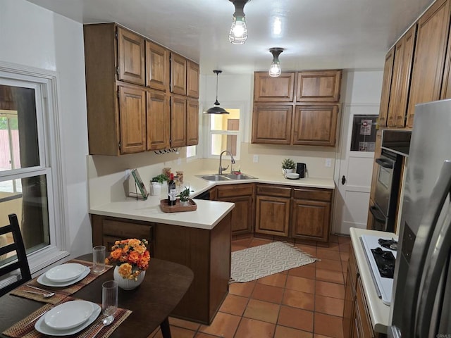2416 J Ave, National City, CA 91950 - kitchen with a sink, a peninsula, stainless steel refrigerator with ice dispenser, and brown cabinetry