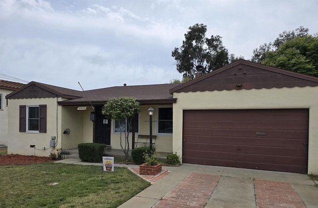 2416 J Ave, National City, CA 91950 - ranch-style home with a garage, stucco siding, and a front lawn
