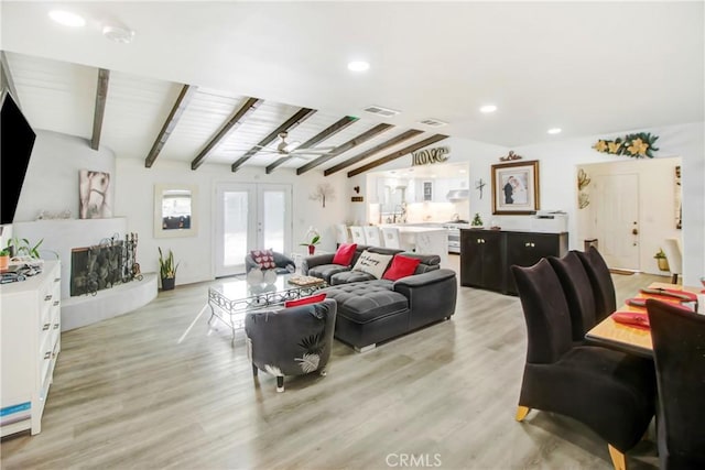 living room featuring french doors, ceiling fan, light hardwood / wood-style flooring, and lofted ceiling with beams