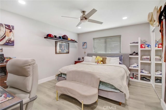 bedroom with ceiling fan and light hardwood / wood-style floors