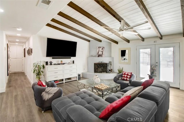 living room with french doors, vaulted ceiling with beams, light hardwood / wood-style floors, ceiling fan, and wooden ceiling