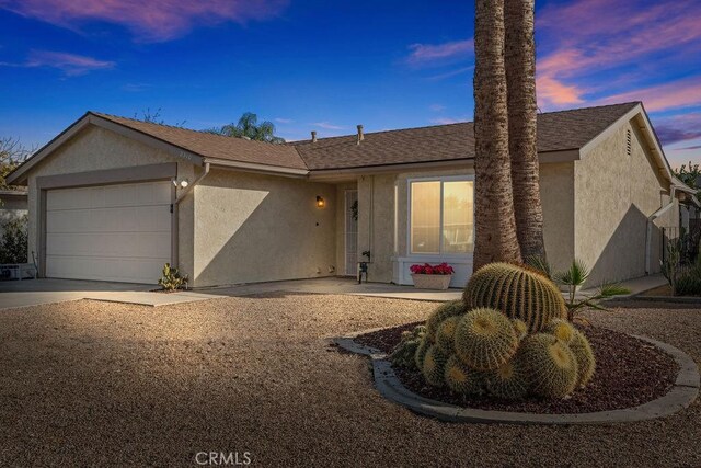 ranch-style home featuring a garage