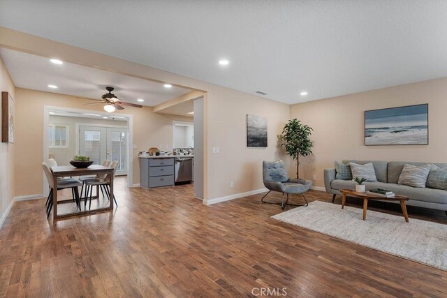 living room featuring french doors, ceiling fan, and wood-type flooring