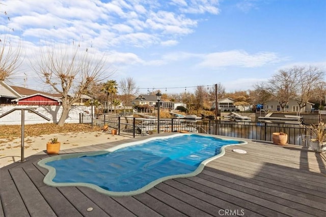 view of swimming pool with a deck with water view