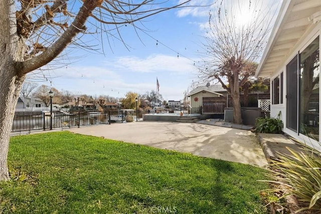 view of yard featuring a water view and a patio