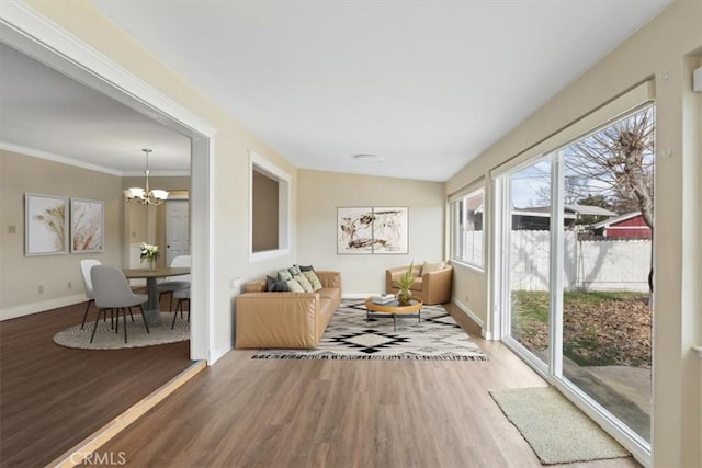 sunroom featuring lofted ceiling and an inviting chandelier