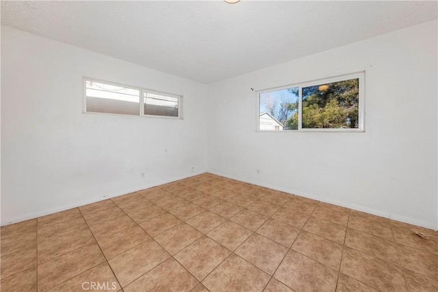 spare room with light tile patterned floors