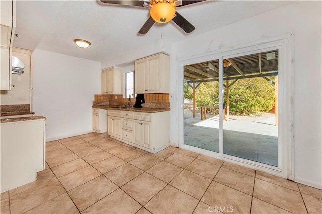 kitchen with light tile patterned floors, extractor fan, ceiling fan, backsplash, and pendant lighting