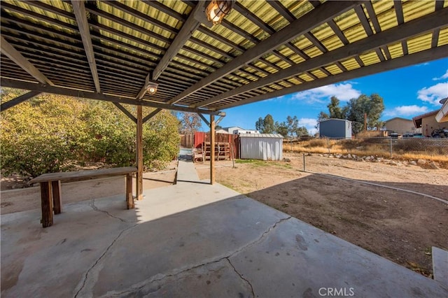 view of patio / terrace featuring a storage shed